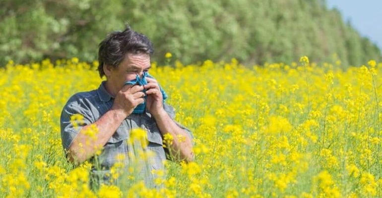 Man-in-field-of-flowers-1080x567
